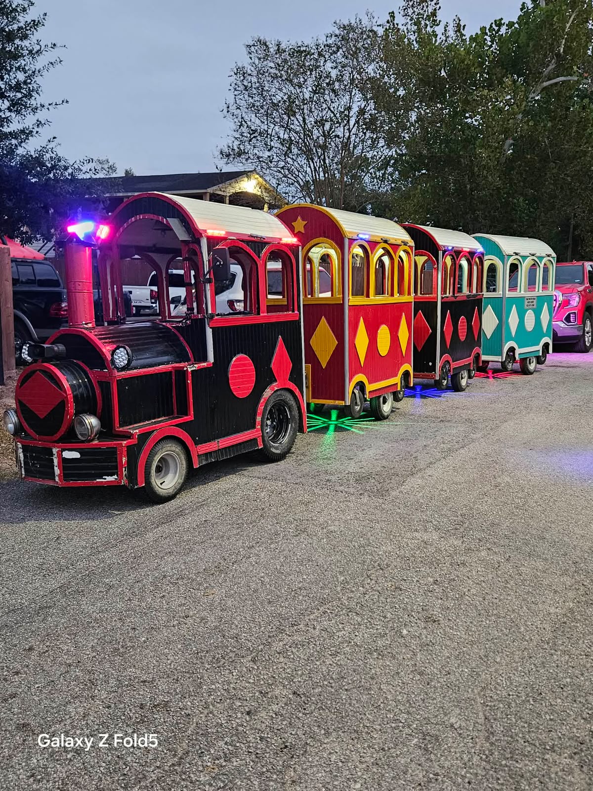 Illuminated trackless train at night