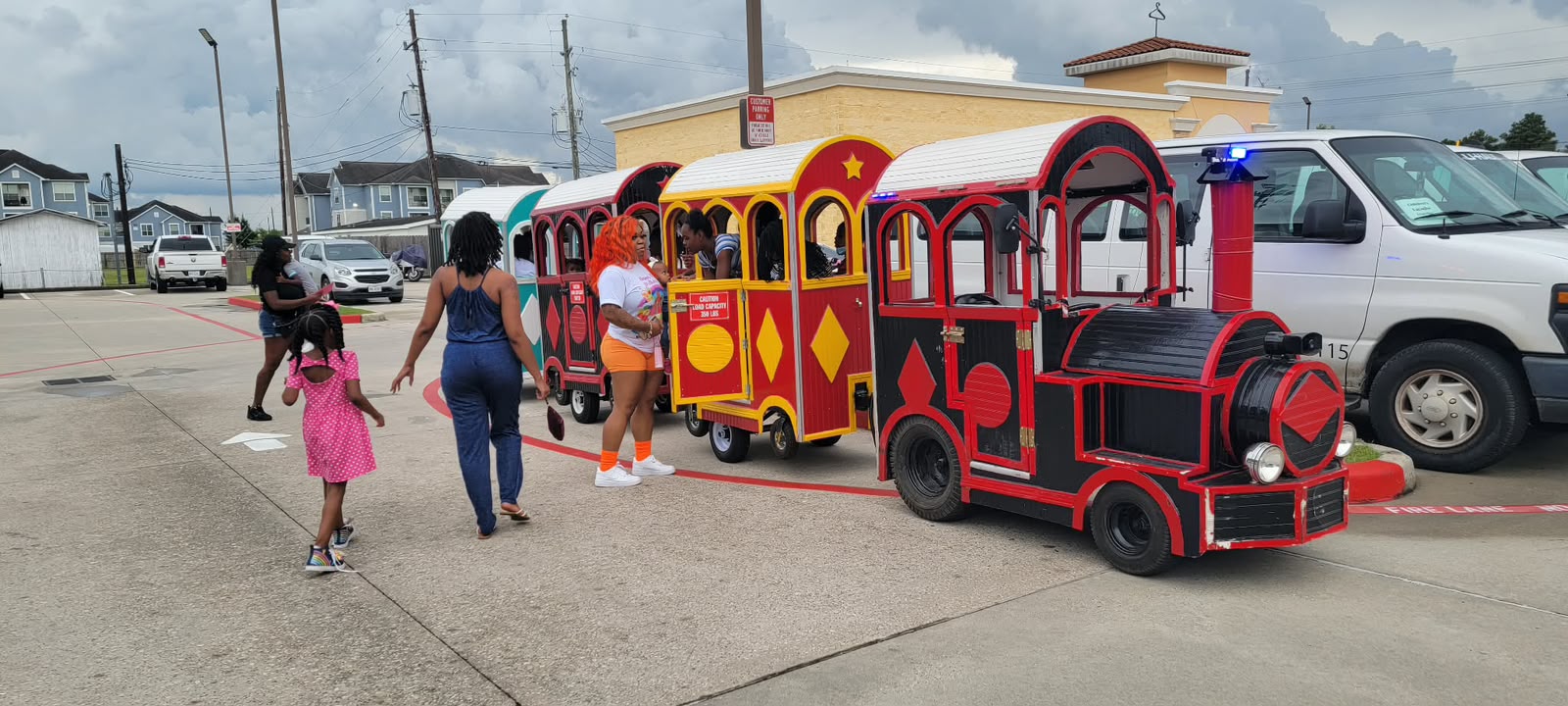 Children enjoying train rides at a celebration